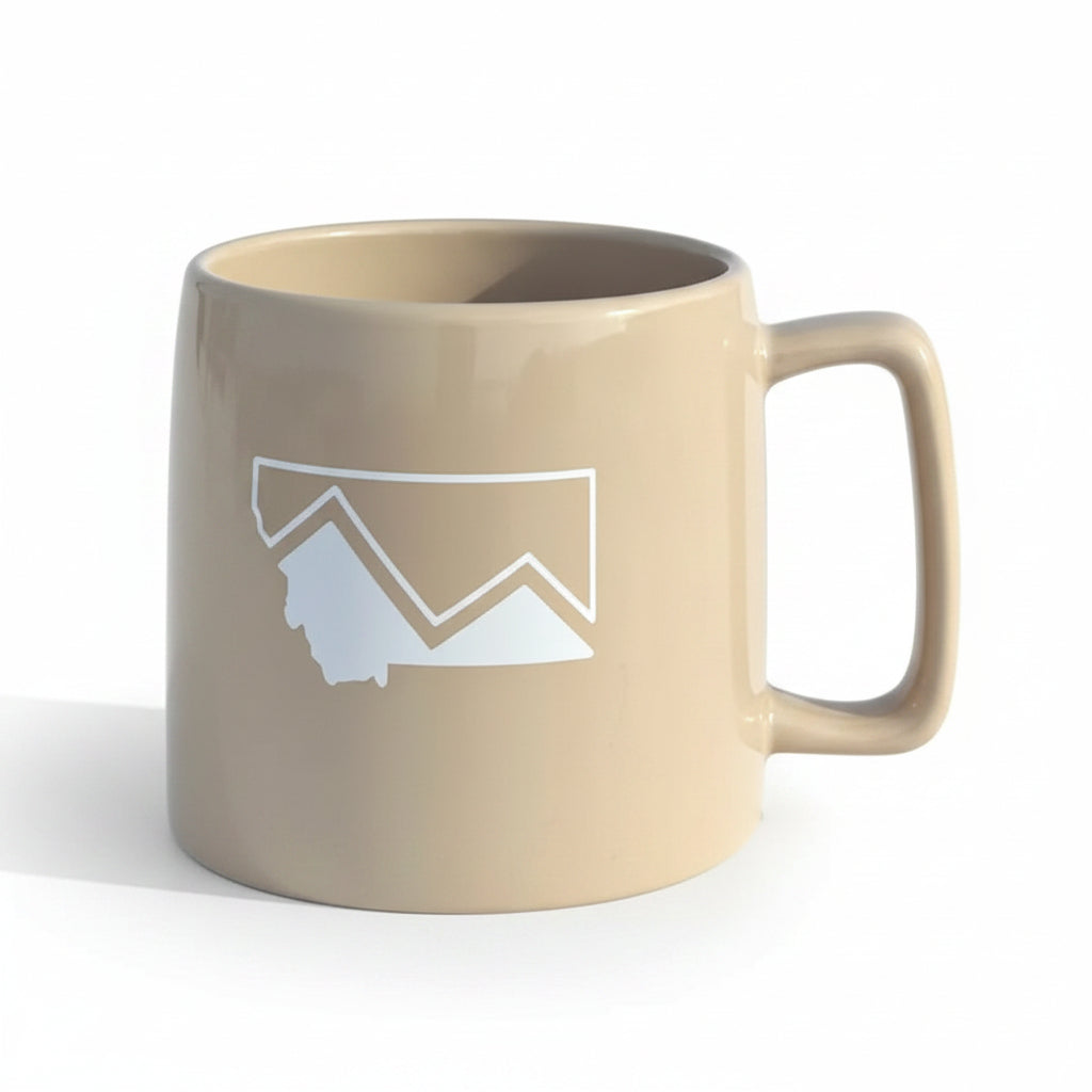 Beige mug with mountain design on a white studio background