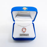 Heart-shaped pendant with Montana sapphire stones in a blue jewelry box.