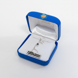 Silver necklace with pendant in a blue jewelry box on a white background