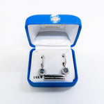 Pair of earrings in a blue jewelry box with 'Montana Sapphire' label.