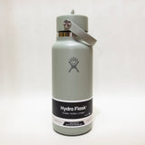 Hydro Flask green water bottle with on a light gray background