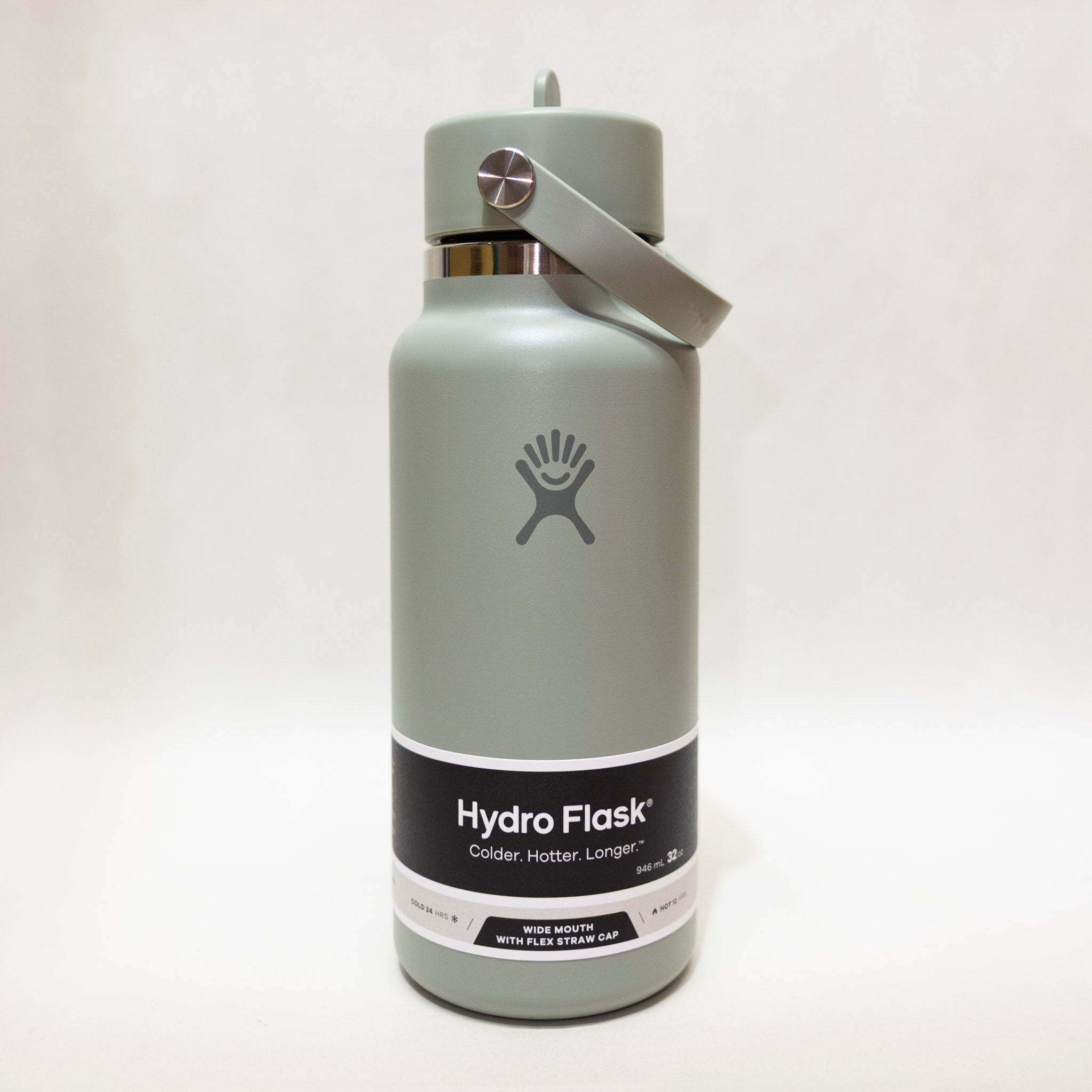 Hydro Flask green water bottle with on a light gray background