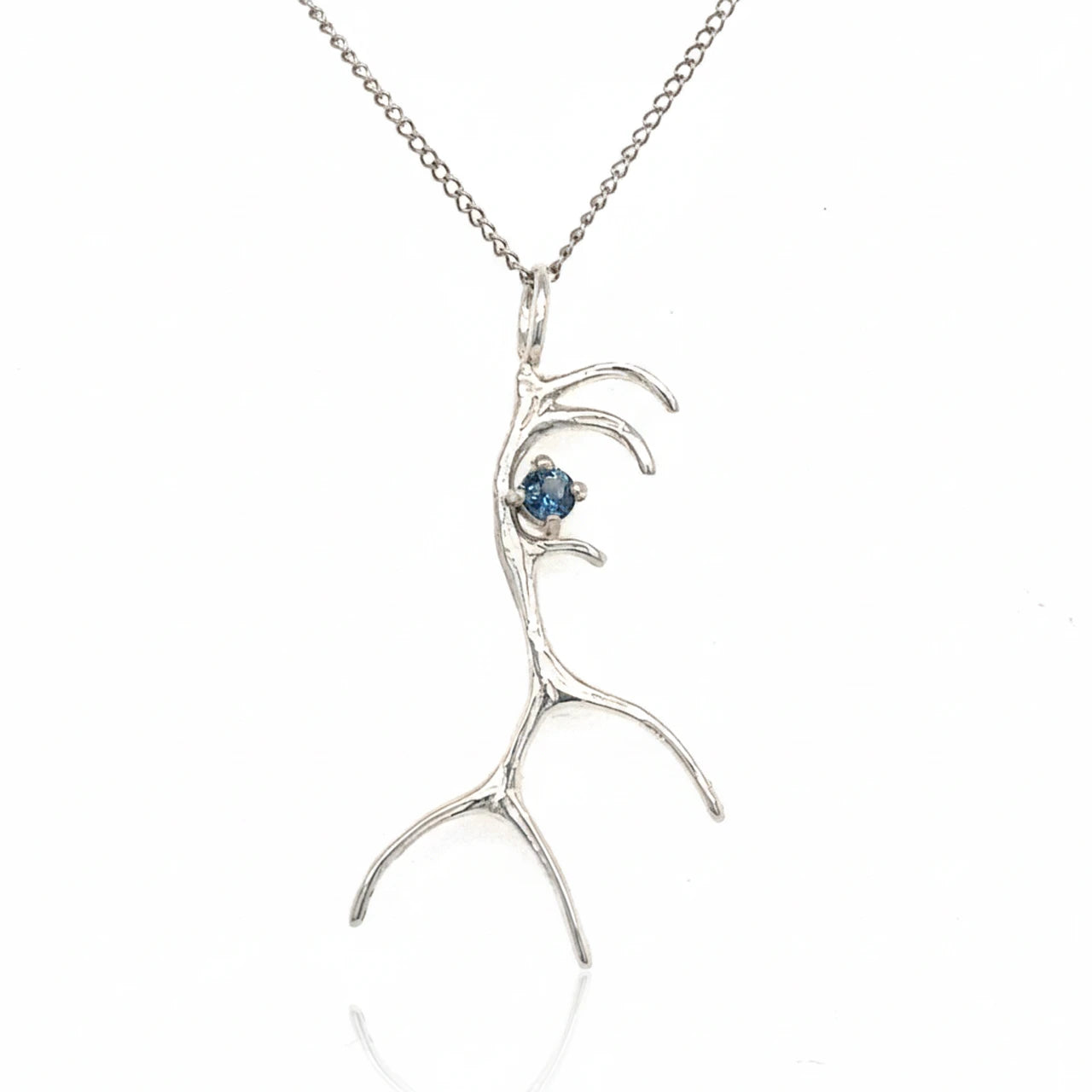 Silver antler-shaped pendant with a blue gemstone on a white background