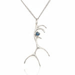 Silver antler-shaped pendant with a blue gemstone on a white background