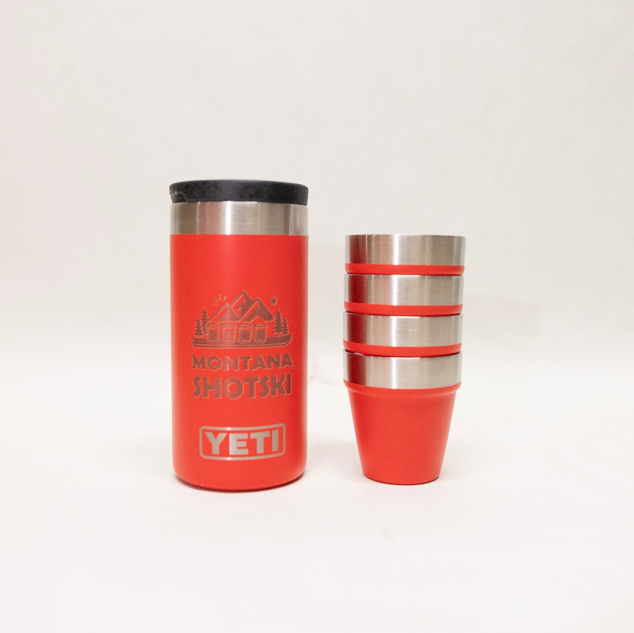 Red YETI tumbler with black lid and stacked design on a white background