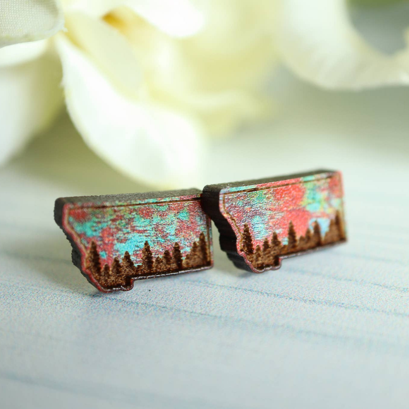 Pair of earrings with a textured design on a light background