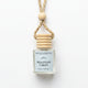 A small glass bottle reed diffuser with a white label reading 'Gallatin Candle Co. Mountain Cabin' and '8 mL / 0.