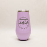 Purple tumbler with mountain design and text on a light gray background