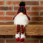 Plush gnome toy with red and black checkered hat and striped socks on a white background