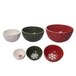 Set of six ceramic bowls in red, green, and white with snowflake designs on a white background.