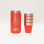 Two orange YETI tumblers on a white background