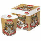 A golden mug with an owl wearing a mushroom and berry crown and a mushroom necklace. It comes in a box with the same art design.