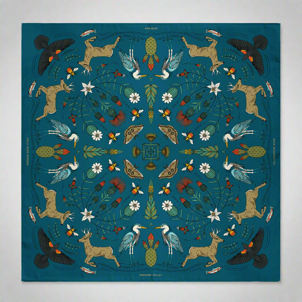 Decorative blanket with nature-themed pattern featuring animals and plants on a blue background