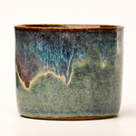 Ceramic pot with a textured surface on a white background