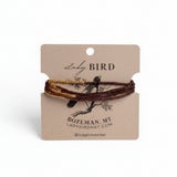 beaded wrap bracelets in gold and dark burgundy on a kraft paper display card from Lady Bird.
