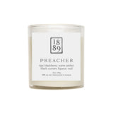 Candle with a label featuring the number 1889 and product description on a white background