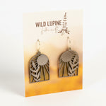 Pair of earrings on a Wild Lupine Folkcraft branded card with a gradient background.