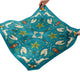 Teal fabric with white rabbit and star pattern held by hands on a white background