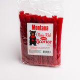 A clear plastic bag of Montana Classic Red Fossil Licorice, showing the red licorice sticks inside. The front features a white label with a black bear logo and red text.