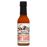 Bottle of Beehive Brothers Ripe Serrano hot sauce on a white background