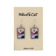 Earrings with mountain and sun design on a 'Nature Cast' branded card.
