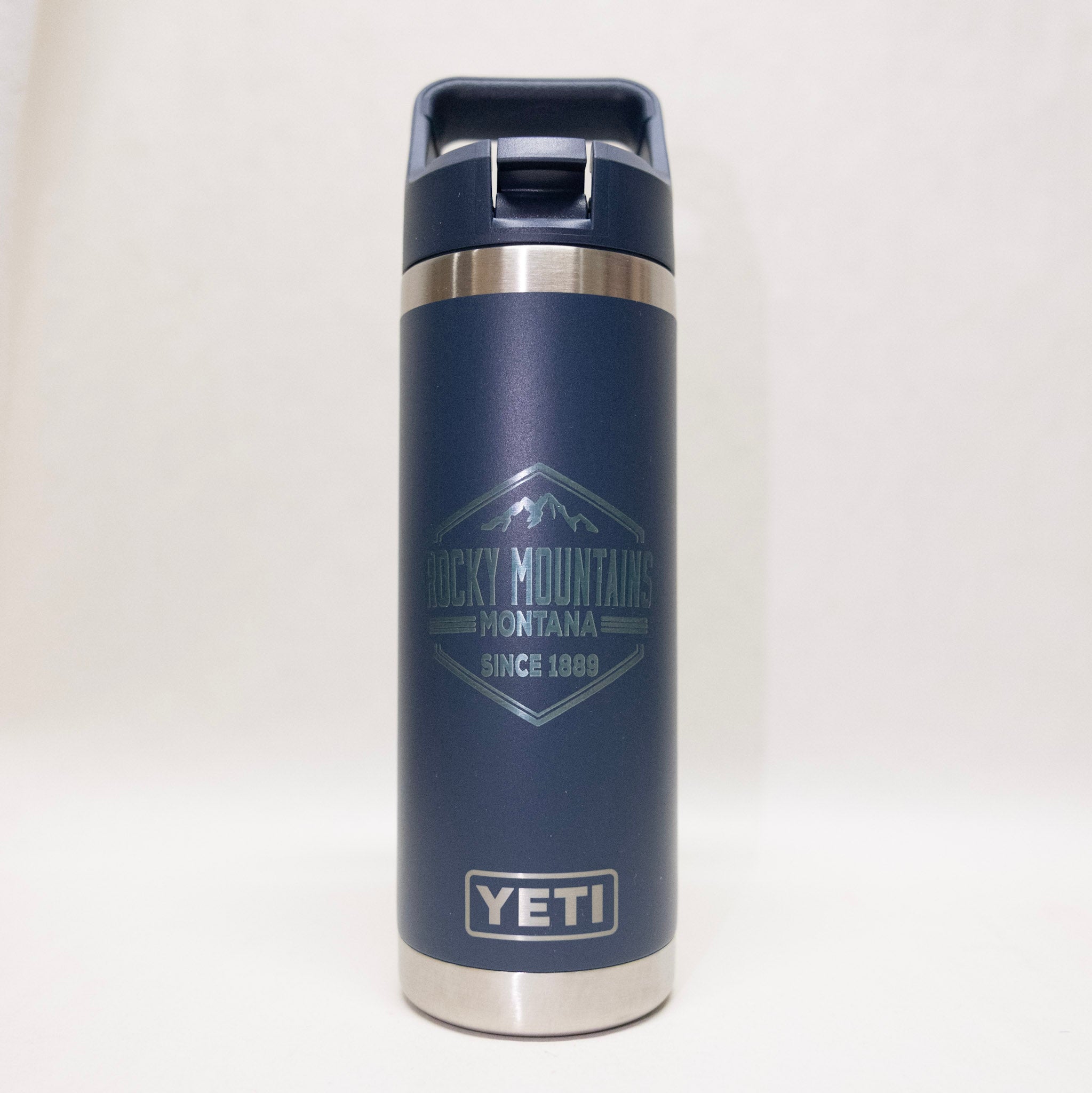 Navy YETI mug with Rocky Mountains Montana logo on a white background