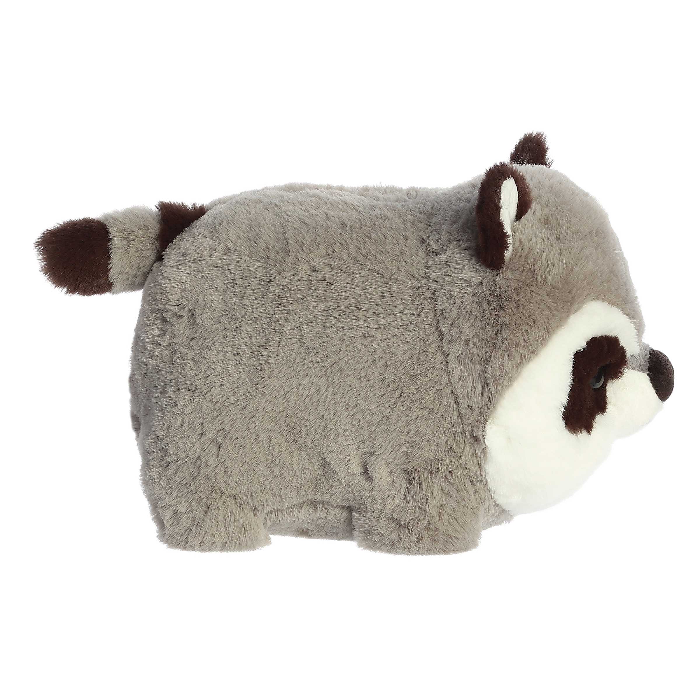 A plush raccoon toy in gray, white, and dark brown, photographed against a plain white background.
