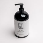 A black pump bottle of RUEL hand cream with a white label, photographed on a clean white background.