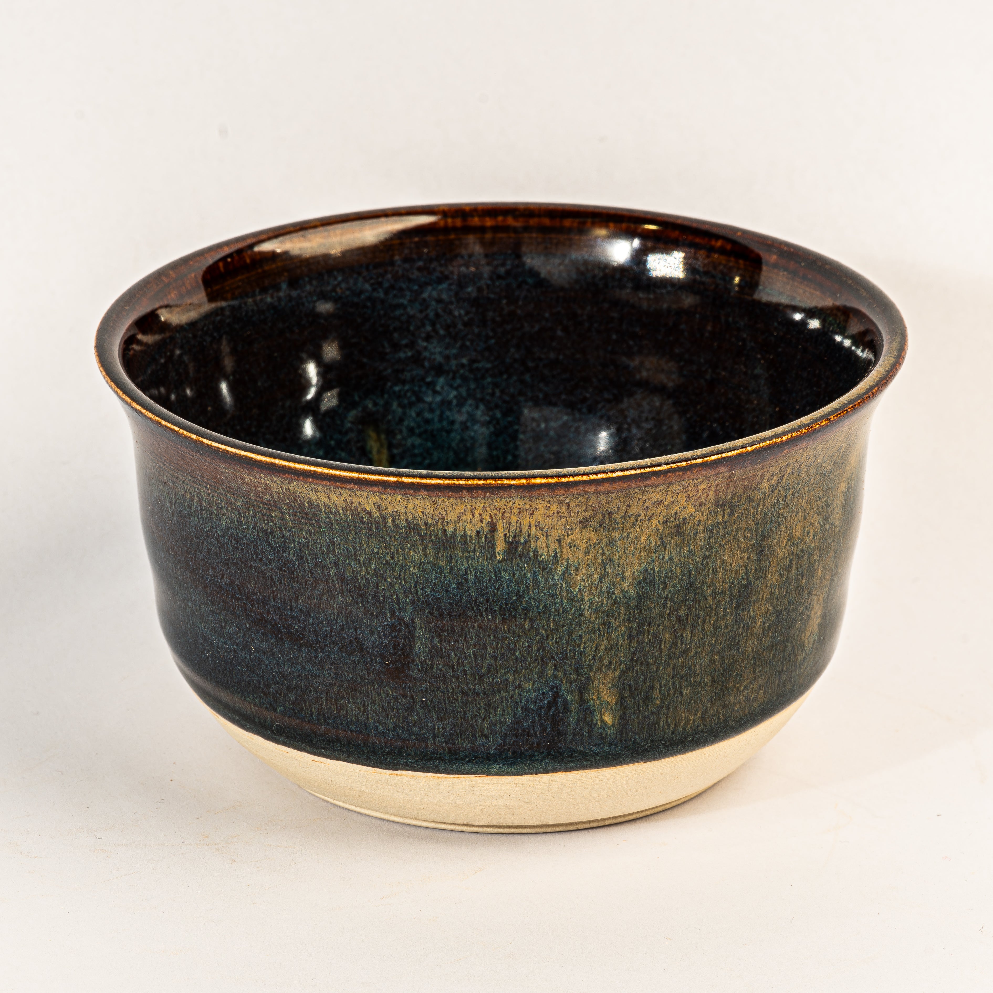 Black ceramic bowl with yellow accents on a white background