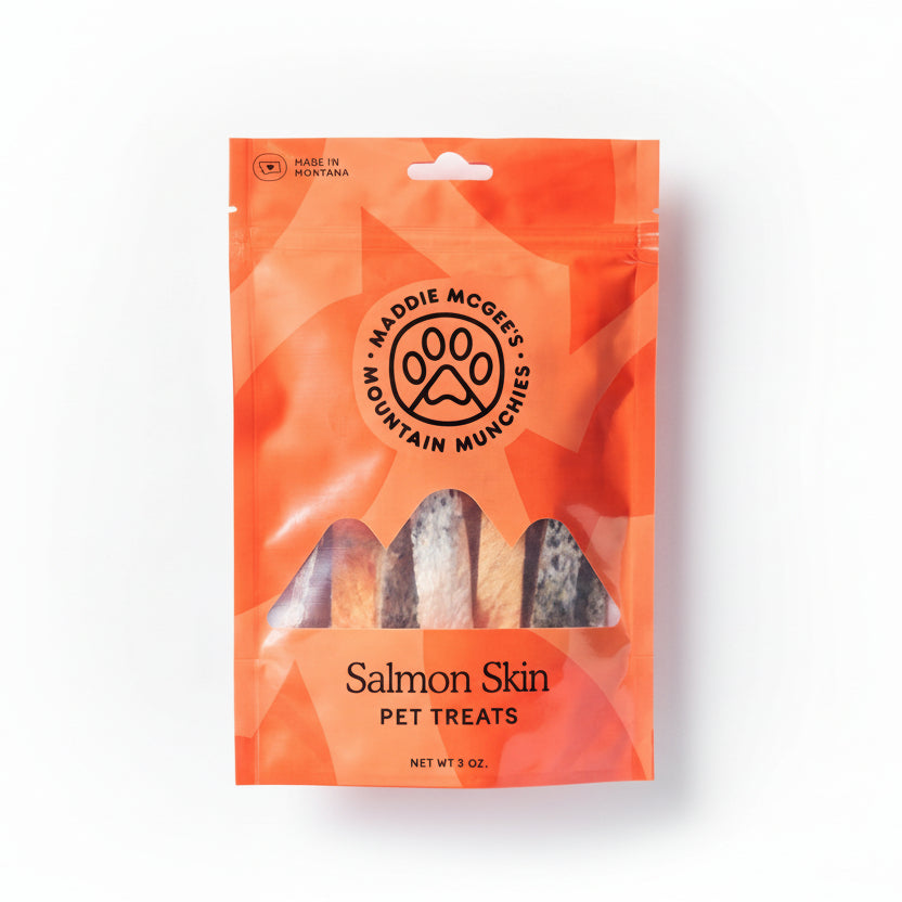 Maddie McGees Mountain Munchies salmon skin pet treats packaging on a gray background