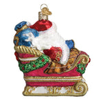 Decorative Christmas ornament of Santa Claus in a sleigh with colorful details on a white background