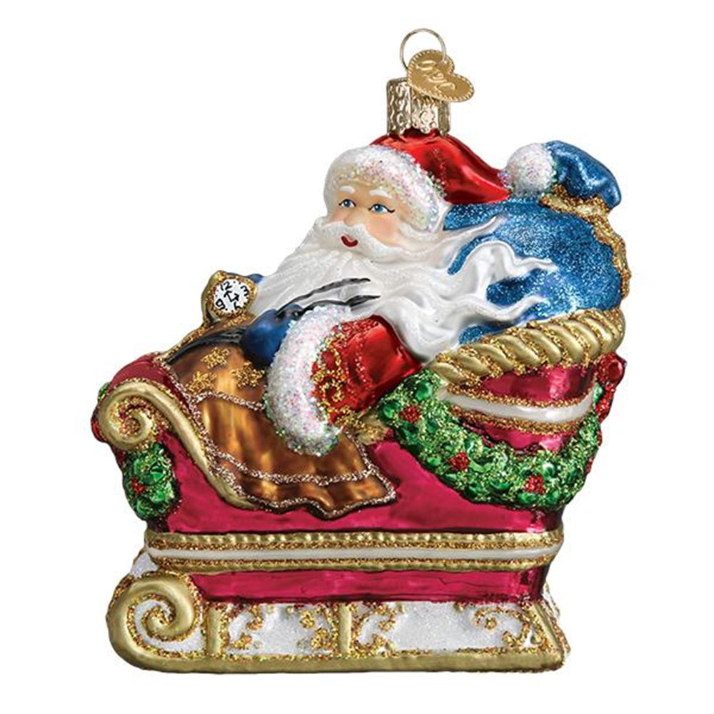 Decorative Christmas ornament of Santa Claus in a sleigh with a white background