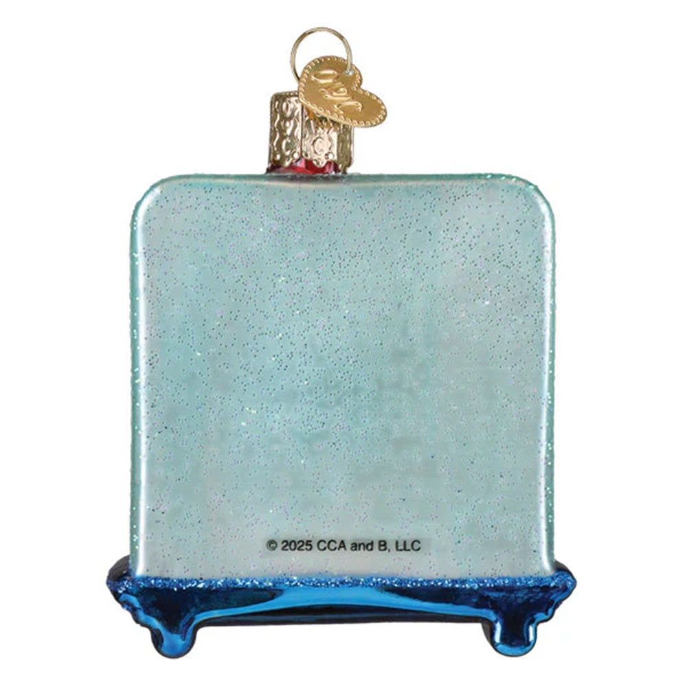 Christmas ornament with an elf by a decorated tree on a white 