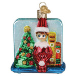 Christmas ornament with an elf by a decorated tree on a white background