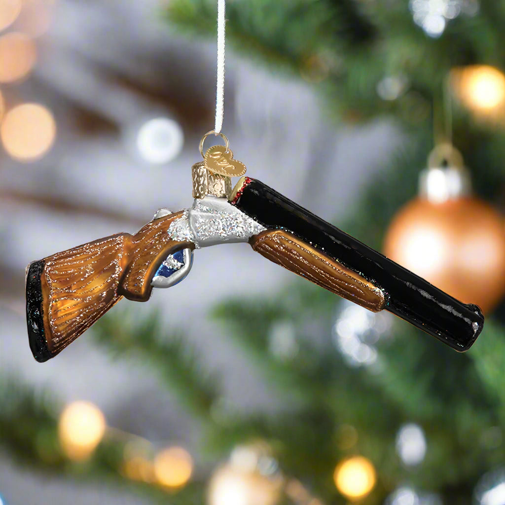 Decorative glass shotgun ornament on a white background