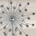 Decorative tree topper with metallic and crystal elements on a neutral background.