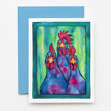 A square art print or greeting card featuring a colorful watercolor-style illustration of three chickens, placed on top of a blue envelope against a white surface.