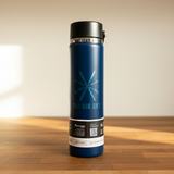 Blue thermos bottle with 'Big Sky' branding on a wooden surface.