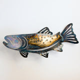Decorative metal fish sculpture on a white background