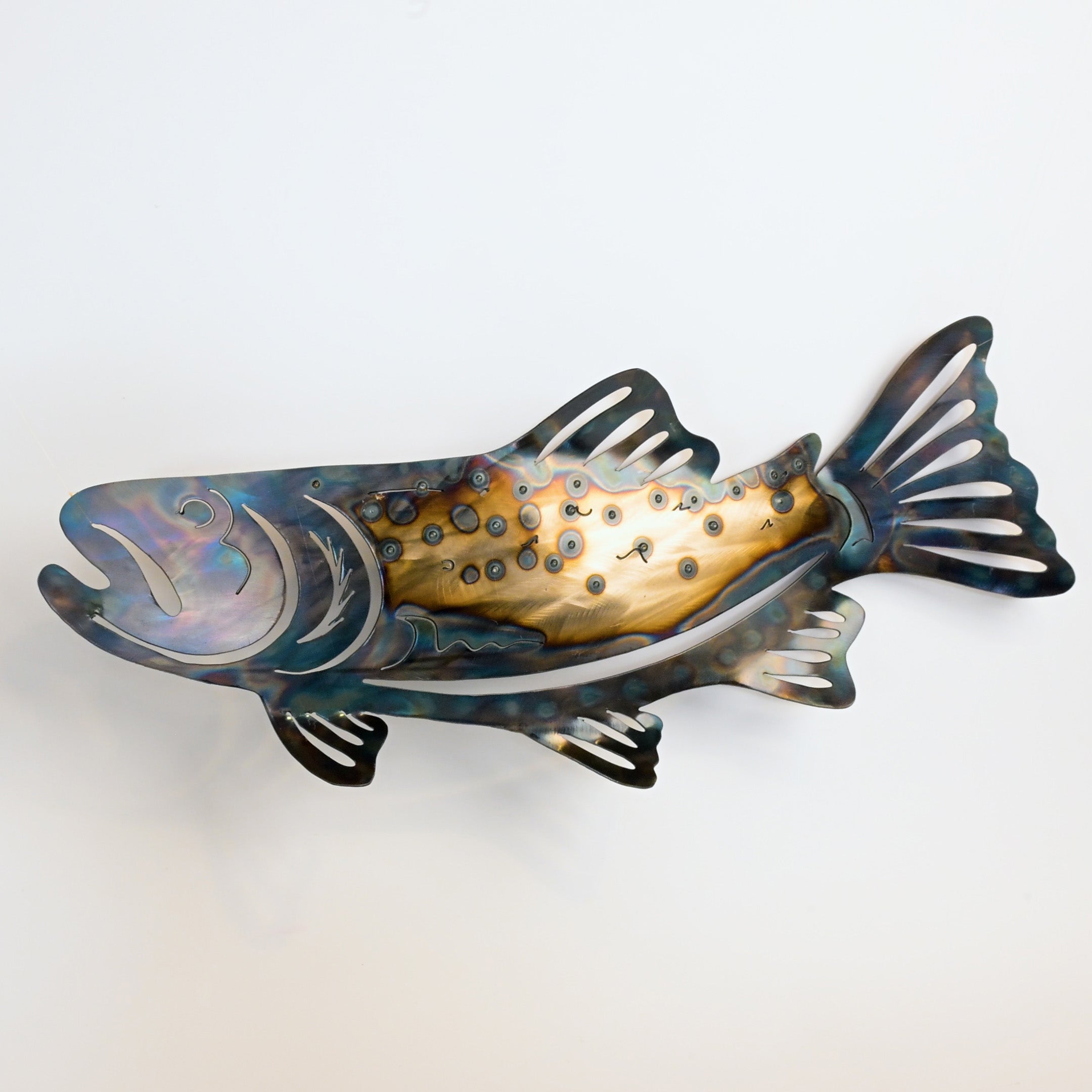 Decorative metal fish sculpture on a white background