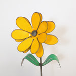 Yellow metal flower sculpture on a white background