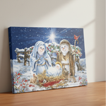 Canvas print of a snowy nativity scene with Mary, Joseph, and baby Jesus on a wooden surface.
