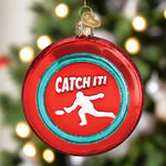 Decorative ornament with 'Catch It!' text and a silhouette of a person catching a disc on a red background.