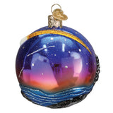Decorative glass ornament with a space-themed design on a white background