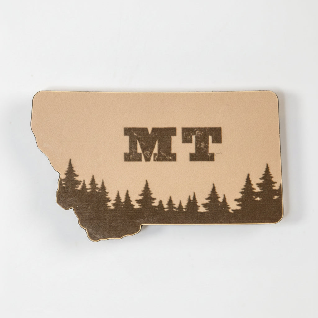 magnet of the state of Montana with trees and 'MT' on a white background