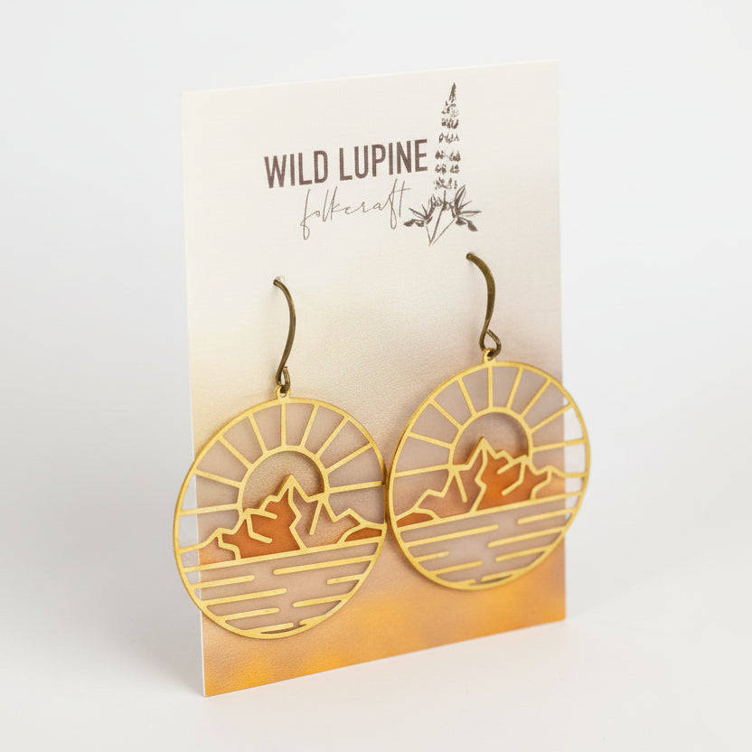 Earrings with mountain design on a Wild Lupine Folkcraft branded card.