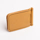 A tan leather money clip wallet with gold-tone metal hardware, black contrast stitching, and an embossed lion logo on the front, shown on a clean white background.