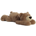 Brown teddy bear lying on a white background
