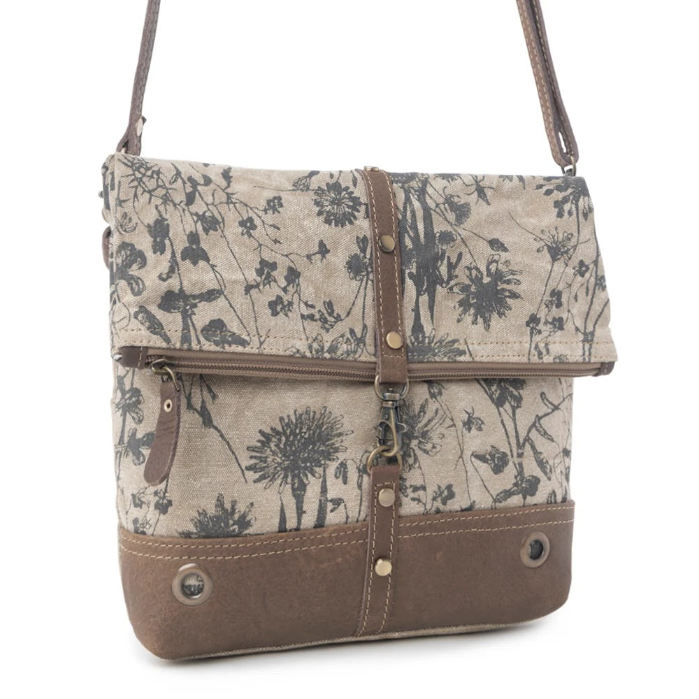 Floral-patterned handbag with brown accents on a white background