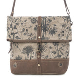 Floral patterned bag with brown accents on a white background
